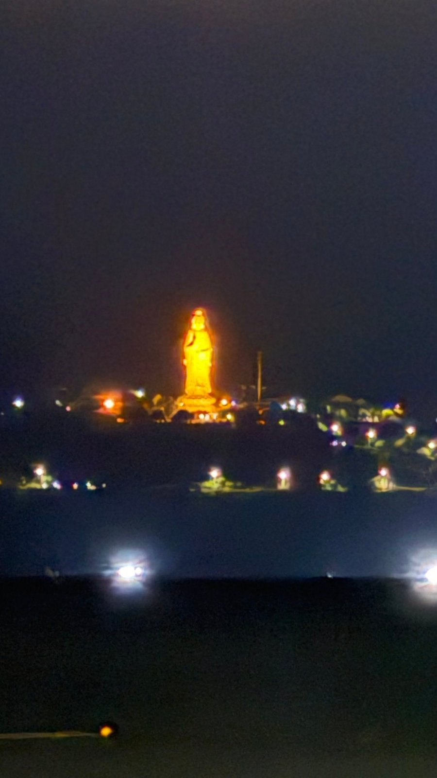 The Lady Buddha, lit up on the side of Sơn Trà.