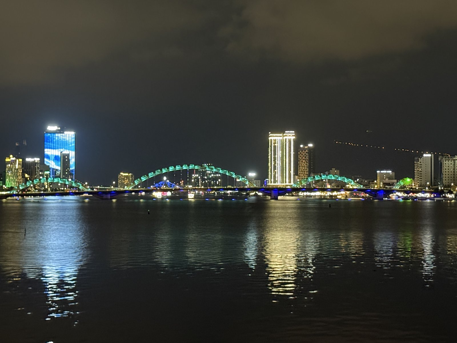 Across the Hàn: the skyline and the Dragon Bridge, lit green.