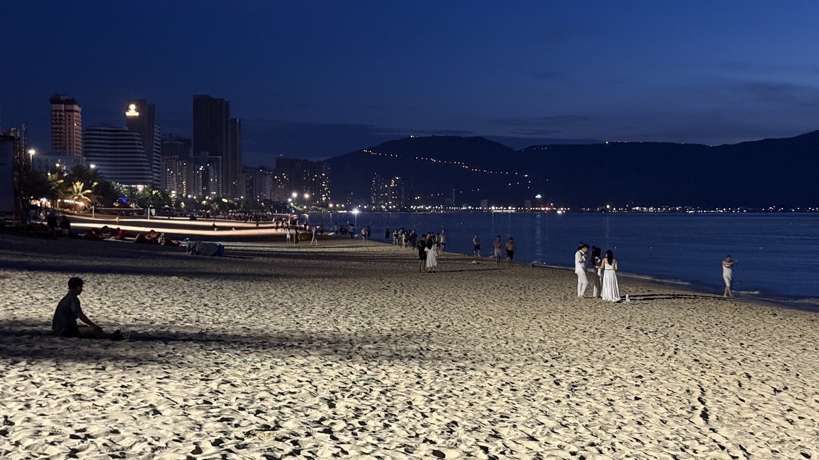 The beach before 5 am, the city still lit.