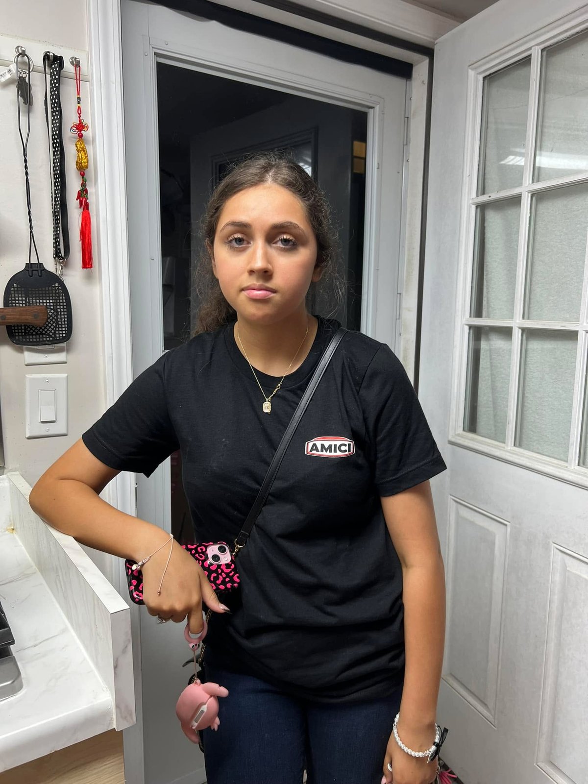 Home from her first day working in a restaurant, in 2024. She worked a double, hostess to dishwasher. She was very tired.
