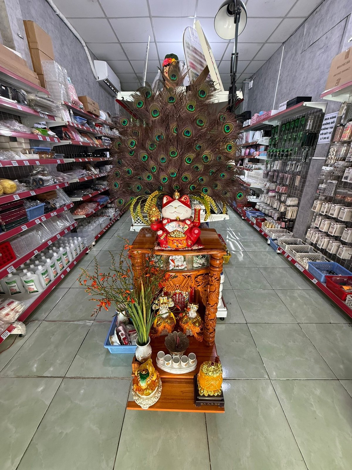 A shop altar, peacock feathers and all.