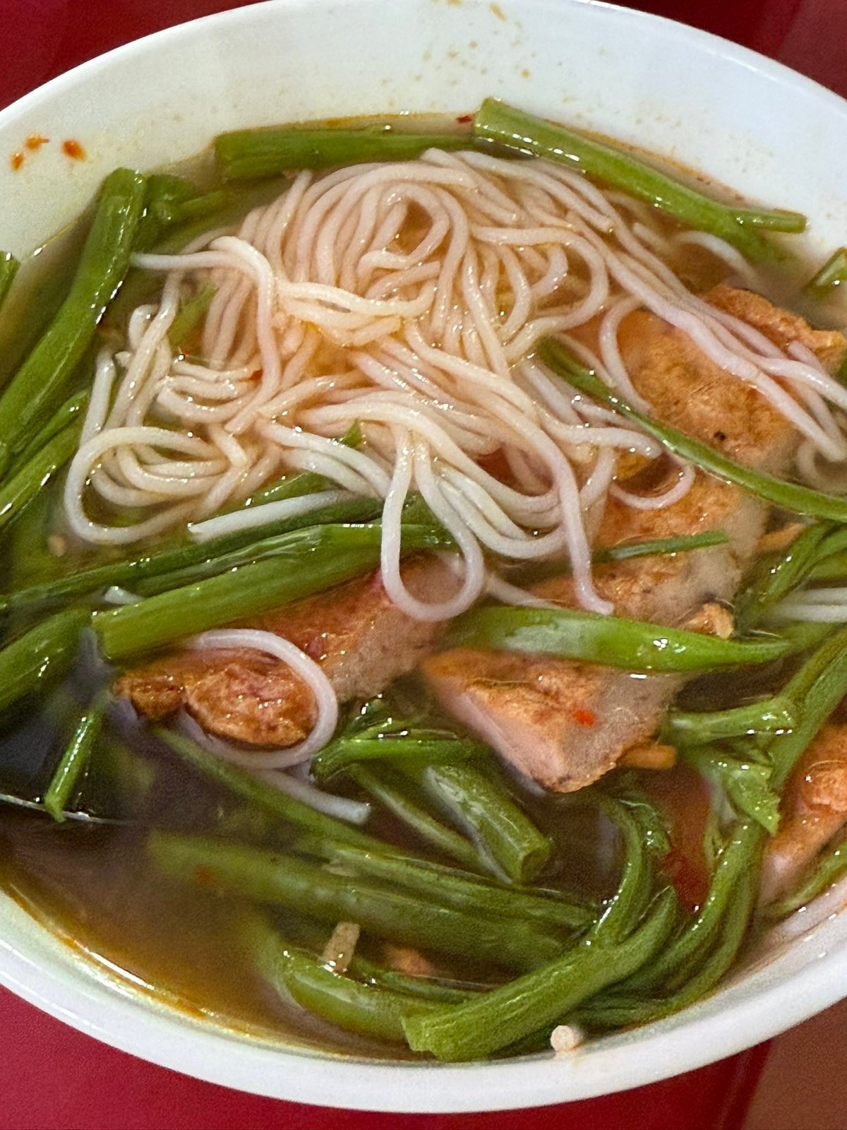 Bún chả cá, among the clothing racks.