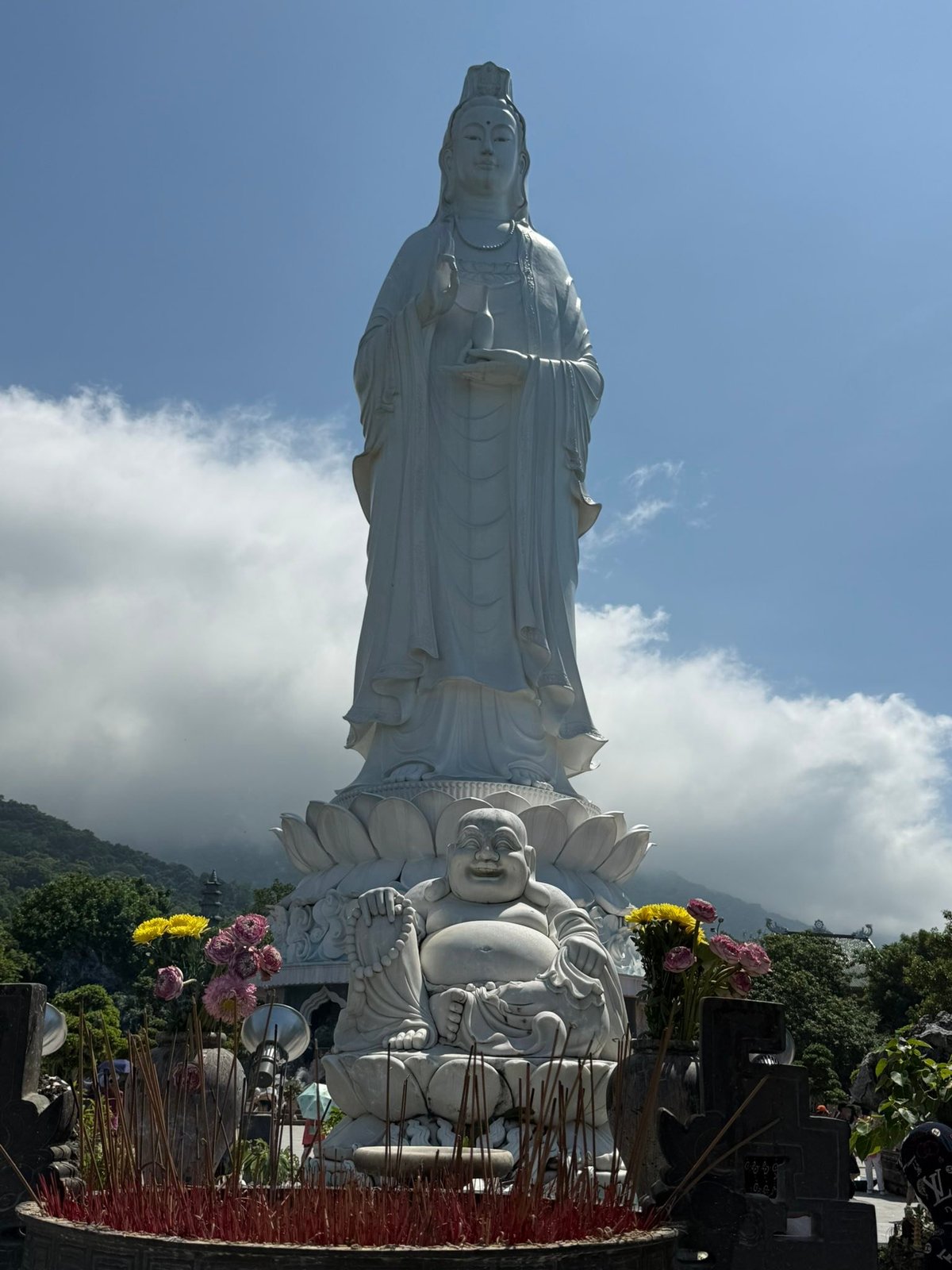 The Lady, with the laughing Budai at her feet and the clouds coming off the mountain.